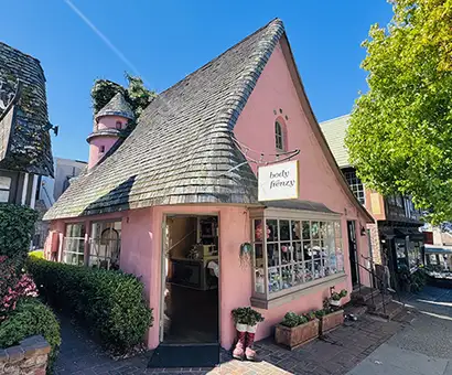 Pink storybook cottage in Carmel-by-the-Sea in the Hugh Comstock architectural style